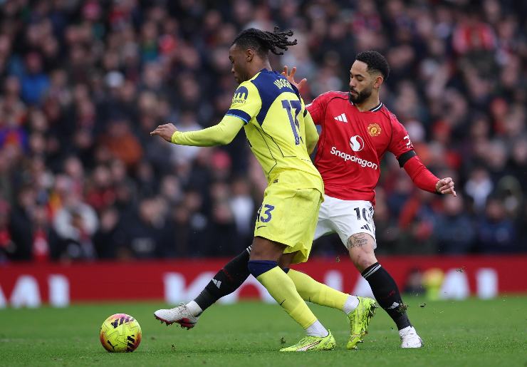 Udogie del Tottenham mentre viene contrastato da un calciatore dello United